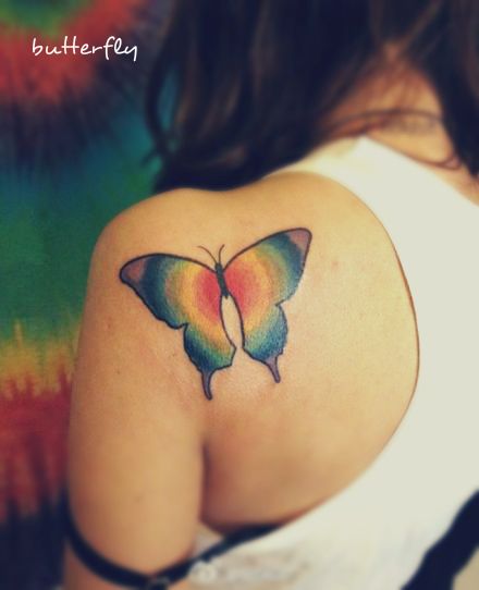 A Butterfly Tattoo On The Back With Colors Of Rainbow Butterfly Tattoo