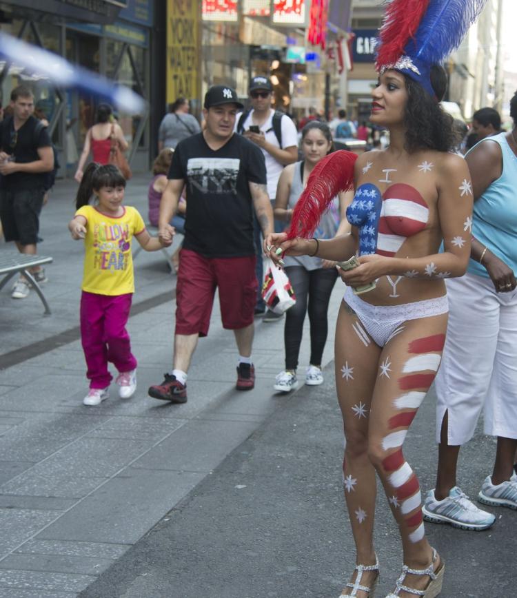 A Child Points To The Naked Female Performers As They Roam Around Times Square Looking