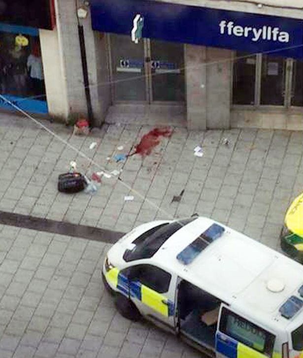 A Massive Pool Of Blood Can Be Seen Outside A Boots Store In Queen Street