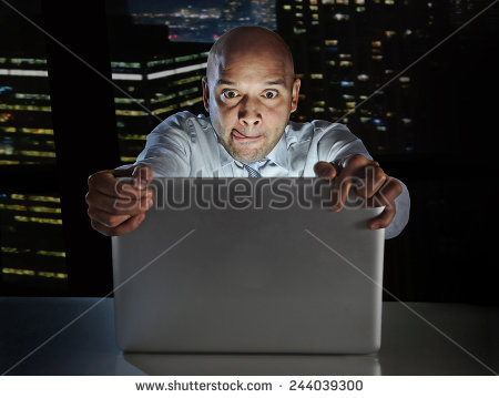 Addict Businessman Alone At Night Sitting At Office Computer Laptop Watching Porn Or Online Gambling Isolated