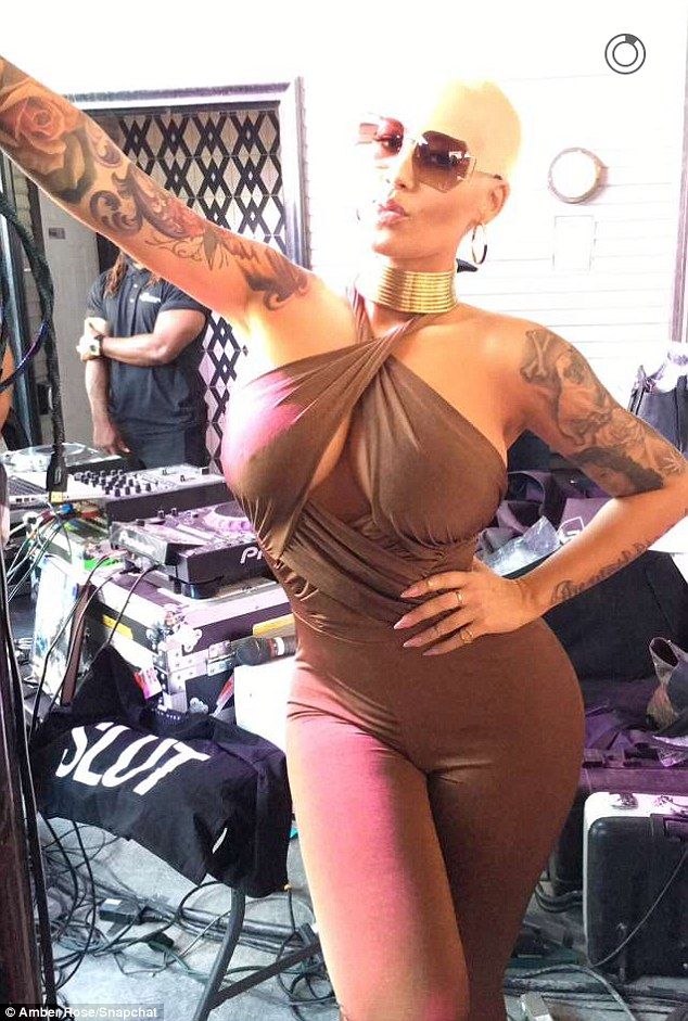 Amber Rose Flaunts Her Cleavage In A Bronze Halter Neck Jumpsuit