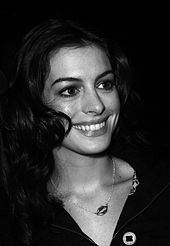 Anne Hathaway Is Smilin To Her Right In The Black And White Picture