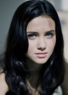 Grey Blue Eyes Black Hair Wavy Female Shoulders Up Portrait