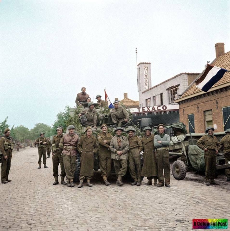 Irish Guards And The Crew Of An Sherman Tank Outside Of A Texaco Garage