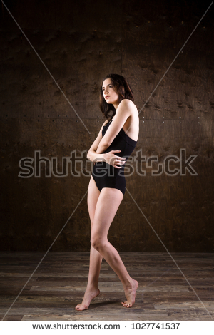 Stock Photo A Very Thin Young Girl Full Length With Her Long Flowing Hair Is Standing In A Black Swimsuit