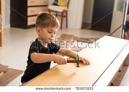 Stock Photo Child Boy Hammers Nails With A Hammer Assembling Furniture At Home