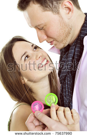 Stock Photo Portrait Of Young Couple Standing Together And Embracing And Holding Condoms Safe Sex Concept